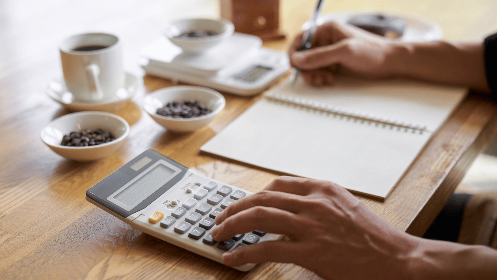 Coffee Shop Owner Calculating Costs 